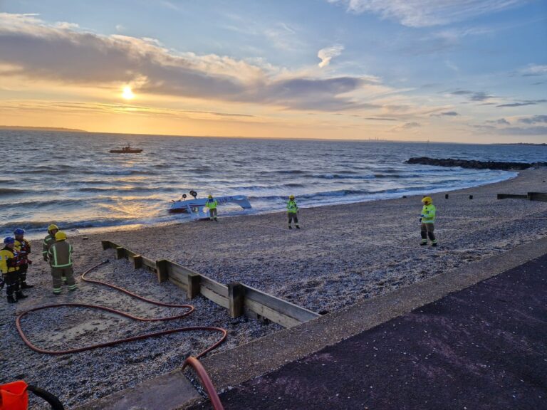 Photo taken at Lee-on-the-Solent beach. Firefighters work on the shingle-covered beach to winch a light aircraft out of the water, so it can be secured. 