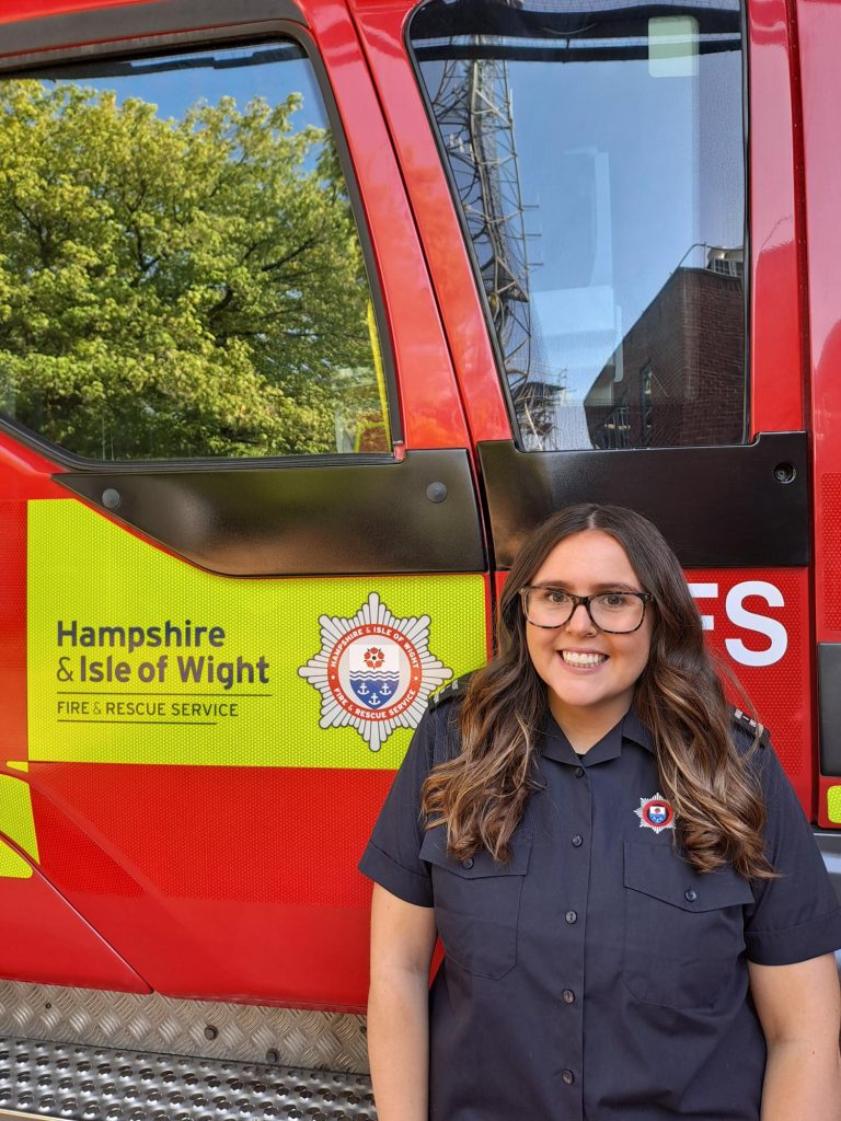 Lottie stood next to a fire engine
